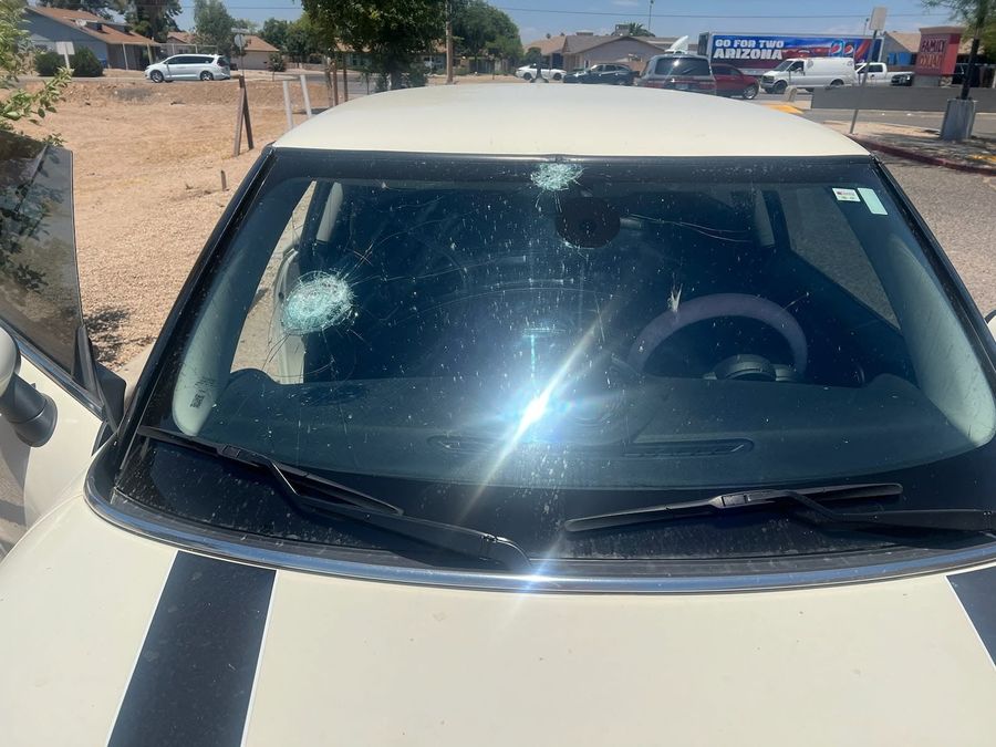 Mini Cooper windshield with two impact breaks, one at the edge and one near the camera