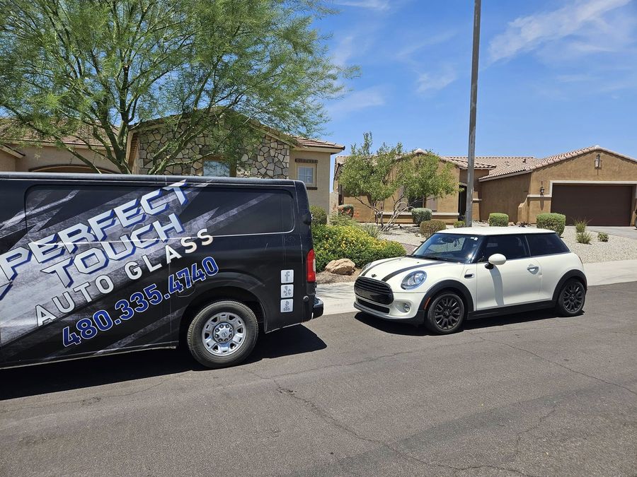 Perfect Touch van parked on the street in front of the Mini Cooper